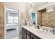 Bathroom with dual sink vanity, framed mirror and access to the bedroom at 327 Alderwood Ln, Atlanta, GA 30328