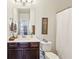 Bathroom featuring a vanity with a mirror, toilet, shower, and hanging towels at 327 Alderwood Ln, Atlanta, GA 30328