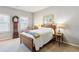 Cozy bedroom with a bed, side table, grandfather clock, and natural light from windows at 327 Alderwood Ln, Atlanta, GA 30328