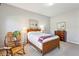 Bedroom featuring a bed, rocking chair, and dresser with pictures, well-lit by a ceiling light at 327 Alderwood Ln, Atlanta, GA 30328