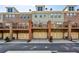 Exterior view of attached townhomes with private decks and garages below at 327 Alderwood Ln, Atlanta, GA 30328