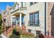 Charming townhome with brick accents, black railings, and colorful landscaping at 327 Alderwood Ln, Atlanta, GA 30328