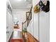 Welcoming hallway with wooden floors, bench, hats, and a view of the living room at 327 Alderwood Ln, Atlanta, GA 30328