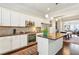 Modern kitchen with white cabinets, stainless steel appliances, and an island with seating at 327 Alderwood Ln, Atlanta, GA 30328