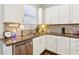Bright kitchen featuring granite countertops, stainless steel appliances, and white cabinetry at 327 Alderwood Ln, Atlanta, GA 30328