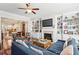Spacious living room with built-in bookshelves, fireplace, and view of the kitchen at 327 Alderwood Ln, Atlanta, GA 30328