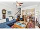 Cozy living room with hardwood floors, open staircase, and plenty of natural light at 327 Alderwood Ln, Atlanta, GA 30328