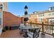 Private patio with outdoor seating, a black and white umbrella, and a lovely neighborhood view at 327 Alderwood Ln, Atlanta, GA 30328