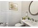 Charming powder room featuring shiplap walls, decorative mirror, and modern fixtures at 327 Alderwood Ln, Atlanta, GA 30328