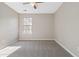 This bedroom features plush gray carpeting, neutral paint tones, and a window letting in natural light at 4284 Hathaway Nw Ct, Kennesaw, GA 30144