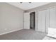 This bedroom features a closet with bifold doors and plush gray carpeting at 4284 Hathaway Nw Ct, Kennesaw, GA 30144