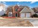 Charming two-story brick home featuring a well-manicured lawn and two-car garage at 4284 Hathaway Nw Ct, Kennesaw, GA 30144