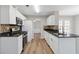 Kitchen features white cabinetry, stainless steel appliances, granite countertops, and tile backsplash at 4284 Hathaway Nw Ct, Kennesaw, GA 30144