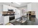 Well-lit kitchen with stainless steel appliances, granite countertops, and a mosaic backsplash at 4284 Hathaway Nw Ct, Kennesaw, GA 30144