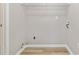 This laundry room features white laminate flooring, white trim, and utility connections at 4284 Hathaway Nw Ct, Kennesaw, GA 30144
