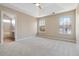 The spacious carpeted main bedroom has an ensuite bathroom and two large windows at 4284 Hathaway Nw Ct, Kennesaw, GA 30144