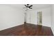 Bedroom with dark hardwood floors, and entry to the bathroom at 448 Cape Ivey Dr, Dacula, GA 30019