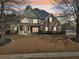 A well-manicured lawn enhances the curb appeal of this two-story brick home at 448 Cape Ivey Dr, Dacula, GA 30019