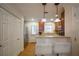 Compact kitchen featuring stainless steel appliances, breakfast bar, and tiled flooring at 6711 Witherington Ct, Norcross, GA 30093