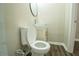 Close up of a bathroom toilet, sink, and vanity with marble countertop and dark wood floor at 1995 Northerly Way, Stone Mountain, GA 30088