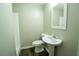 Bright bathroom featuring a shower with tile surround, modern fixtures, and a new pedestal sink at 1995 Northerly Way, Stone Mountain, GA 30088