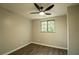 Bright bedroom featuring a ceiling fan, window with blinds, and wood flooring at 1995 Northerly Way, Stone Mountain, GA 30088