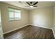 Comfortable bedroom with a ceiling fan, large window, and light wood flooring at 1995 Northerly Way, Stone Mountain, GA 30088