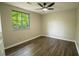 Well-lit bedroom features a large window and light wood flooring at 1995 Northerly Way, Stone Mountain, GA 30088