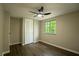 Charming bedroom with built-in closet, window, light wood floors and modern ceiling fan at 1995 Northerly Way, Stone Mountain, GA 30088