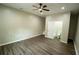 Spacious bedroom features a ceiling fan and an ensuite bathroom with modern finishes and light wood floors at 1995 Northerly Way, Stone Mountain, GA 30088