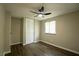 Serene bedroom with a built-in closet, window, light wood floors and modern ceiling fan at 1995 Northerly Way, Stone Mountain, GA 30088