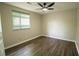 Cozy bedroom featuring wood-look floors, neutral paint, and a ceiling fan at 1995 Northerly Way, Stone Mountain, GA 30088