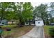 Charming home featuring mature trees, front yard, and driveway at 1995 Northerly Way, Stone Mountain, GA 30088