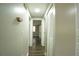 Hallway with wood floors, white doors, and neutral walls offers access to various areas of the home at 1995 Northerly Way, Stone Mountain, GA 30088