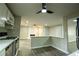 Open kitchen and living space featuring updated cabinets, modern lighting, and stylish new laminate flooring at 1995 Northerly Way, Stone Mountain, GA 30088