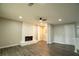 Spacious living room featuring a cozy fireplace, recessed lighting, and modern flooring at 1995 Northerly Way, Stone Mountain, GA 30088