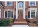 Detailed front entrance featuring brick steps and a wood door flanked by windows at 2760 Sugarloaf Club Dr, Duluth, GA 30097