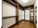 Spacious walk-in closet with built-in shelves and hardwood floors at 2760 Sugarloaf Club Dr, Duluth, GA 30097