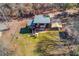 Aerial view of the home with a large yard, small barn, and metal carport at 2762 Zingara Ne Rd, Conyers, GA 30012