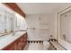 Bright bathroom with a wooden vanity and sink, toilet, and shower with tile accents at 2762 Zingara Ne Rd, Conyers, GA 30012