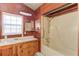 Functional bathroom with double sinks, a shower/tub combo, and wood-paneled accents at 2762 Zingara Ne Rd, Conyers, GA 30012