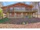 Exterior view of a rustic home with a large balcony at 2762 Zingara Ne Rd, Conyers, GA 30012