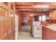 Rustic kitchen features wood paneling, vintage appliances, and an adjacent living space at 2762 Zingara Ne Rd, Conyers, GA 30012