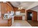 Well-lit kitchen features wood cabinets, white appliances, and tile flooring at 2762 Zingara Ne Rd, Conyers, GA 30012