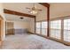 Spacious living room featuring exposed beams, large windows, and a unique brick accent wall at 2762 Zingara Ne Rd, Conyers, GA 30012