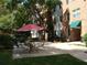 Outdoor patio area featuring an umbrella, table, and chairs beside a brick building at 2965 Pharr Court South Nw # 110, Atlanta, GA 30305