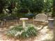 Community grounds with benches and a bird bath surrounded by greenery in a tranquil setting at 2965 Pharr Court South Nw # 110, Atlanta, GA 30305