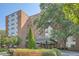 Brick apartment building with a covered entrance, green landscaping, and concrete driveway at 2965 Pharr Court South Nw # 110, Atlanta, GA 30305