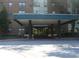 Front entrance with a covered awning and black pillars in front of the brick apartment building at 2965 Pharr Court South Nw # 110, Atlanta, GA 30305