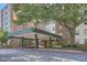 View of the apartment building entrance with awning, concrete pillars, and a paved driveway at 2965 Pharr Court South Nw # 110, Atlanta, GA 30305